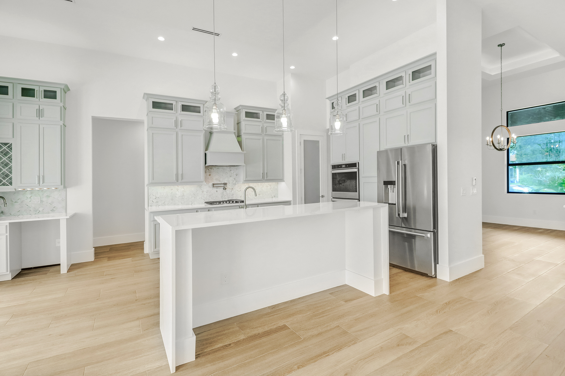 kitchen and dining room with transitional lighting